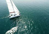 multihull yacht trimaran with dinghy tender boat aerial